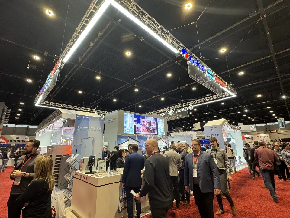 GREE reception counter with visitors and truss lights overhead