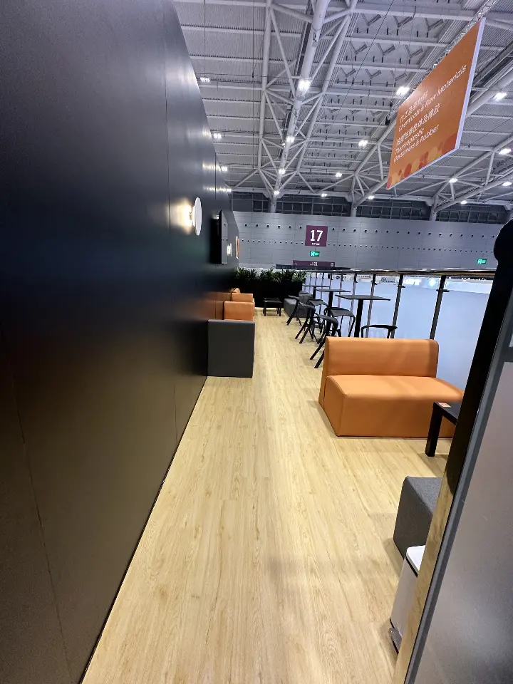 Portrait view of the lounge with orange seating and dark walls