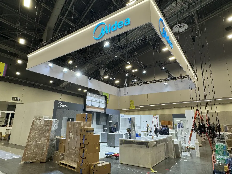 During installation: Midea logo on the suspended frame with pallets stacked below