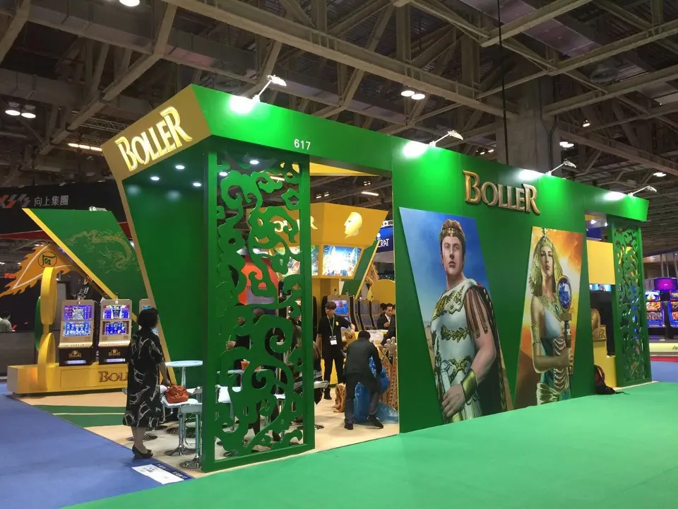 Corner view of green cut-pattern panels, BOLLER fascia and printed figures