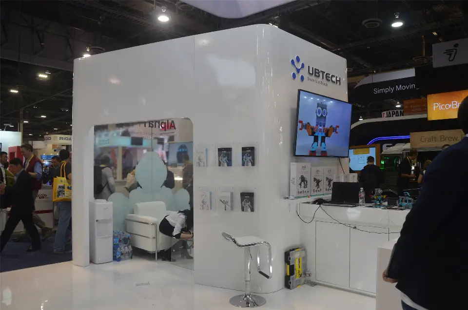 White UBTECH wall with robot display niche, wall screen and stool