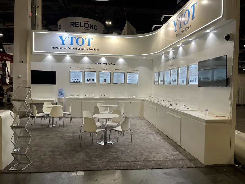 Inside the YTOT booth with round tables, display cabinets and screens