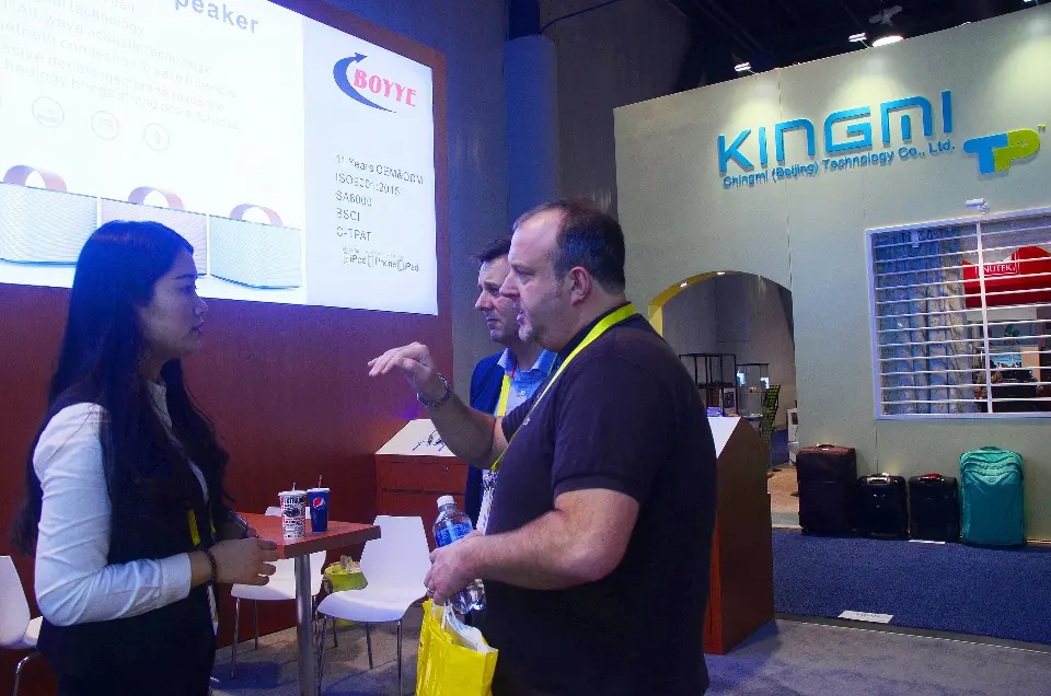 Staff showing speaker products to visitors near the counter