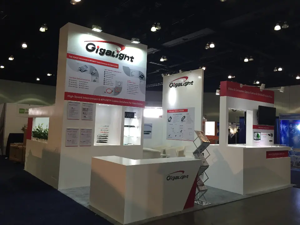 Gigalight booth corner with tall tower, branded counter and literature rack