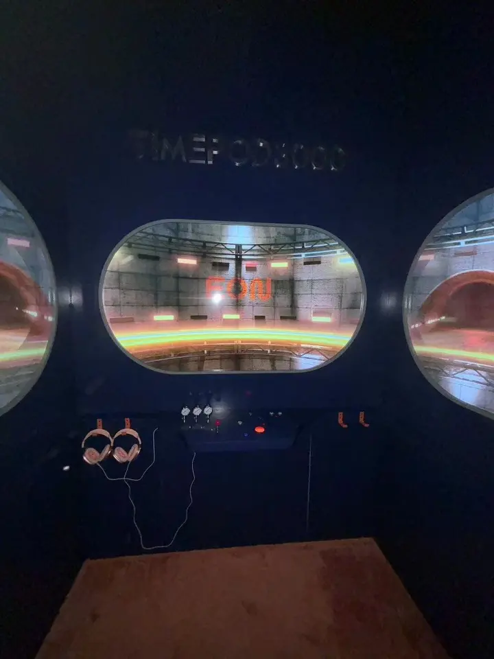 Second view of the dark room with oval lit windows