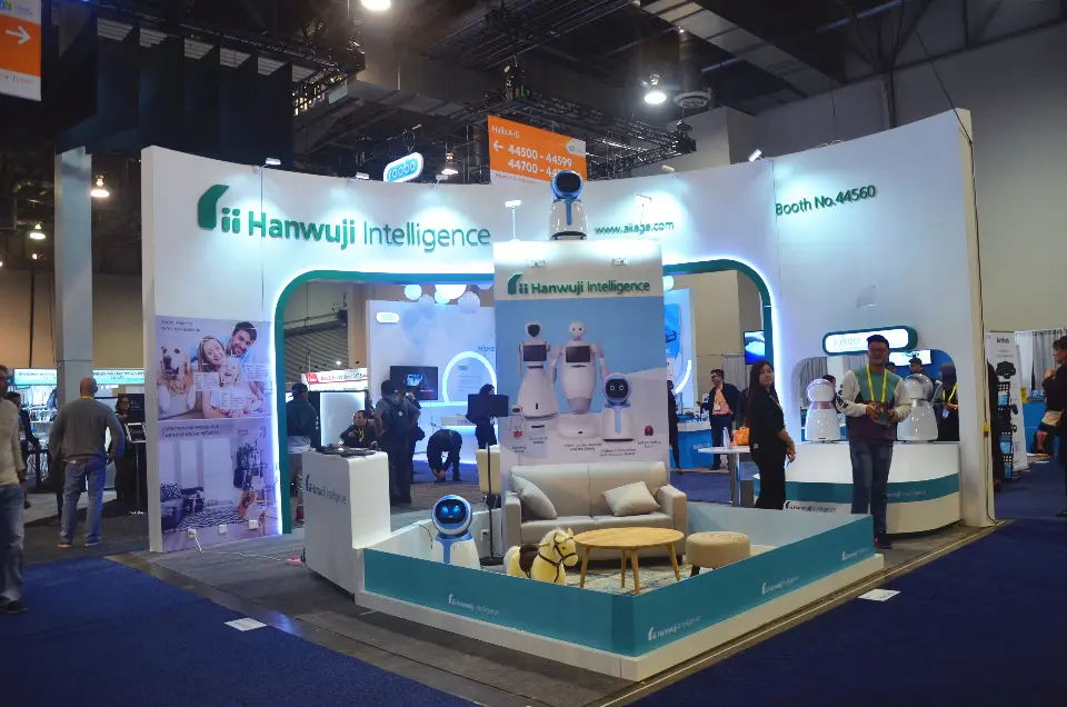 Hanwuji Intelligence booth at CES 2017 with curved white walls, teal arches and a living-room robot set
