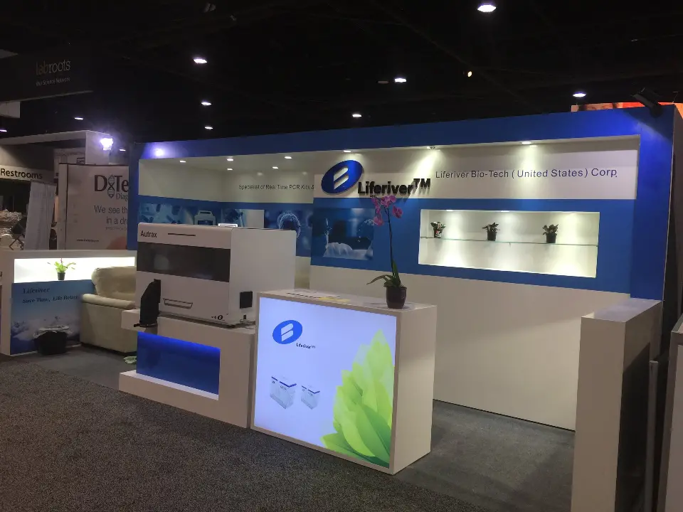 Angled view along the blue fascia with lit niches and lab equipment on the counter