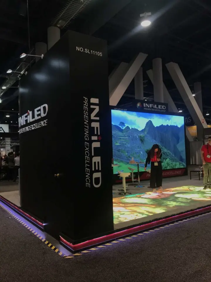 Black corner tower with vertical INFiLED branding above a lit floor display