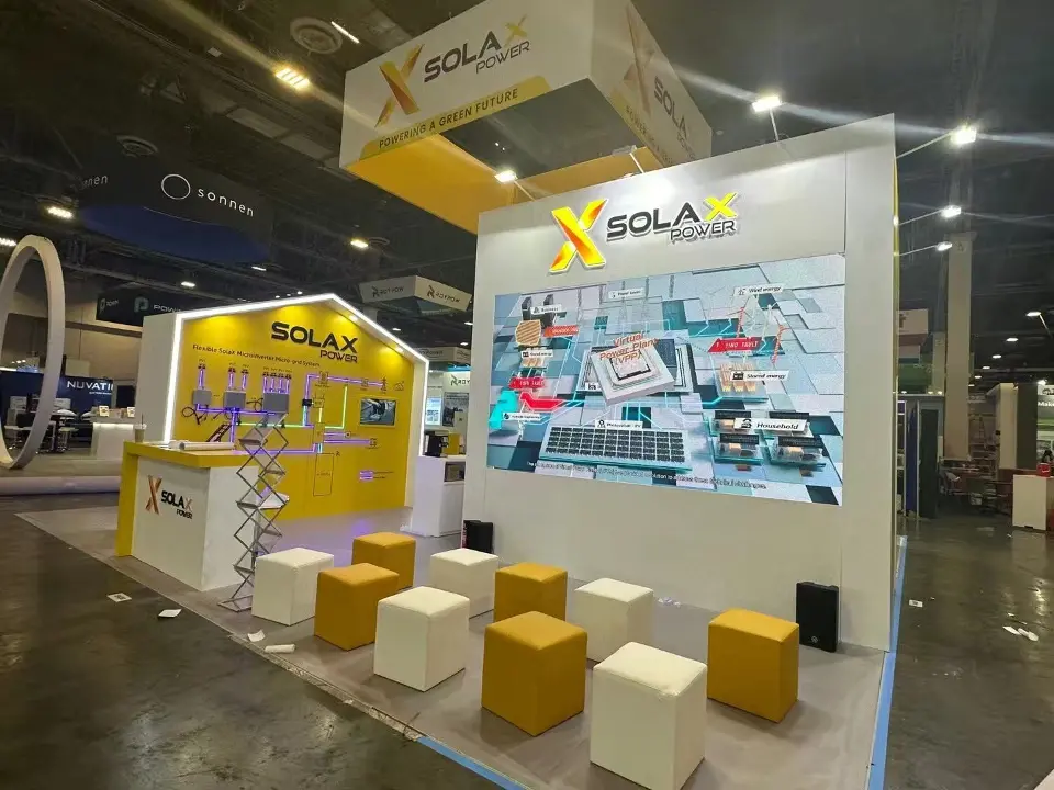 Rear side of the SolaX Power stand with a large graphic wall and yellow and white cube seats