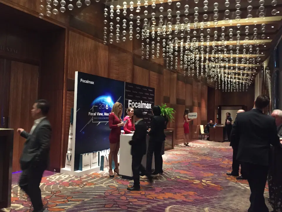 Foyer view of the Focalmax backlit wall with guests and a host nearby