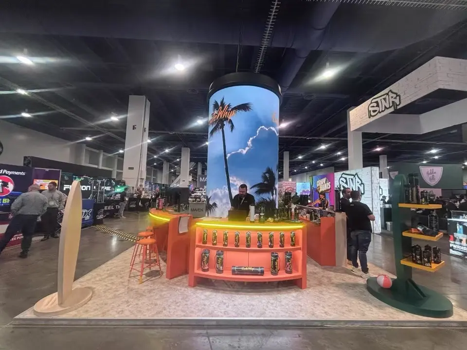 Front of the orange bar counter under a palm-scene video column