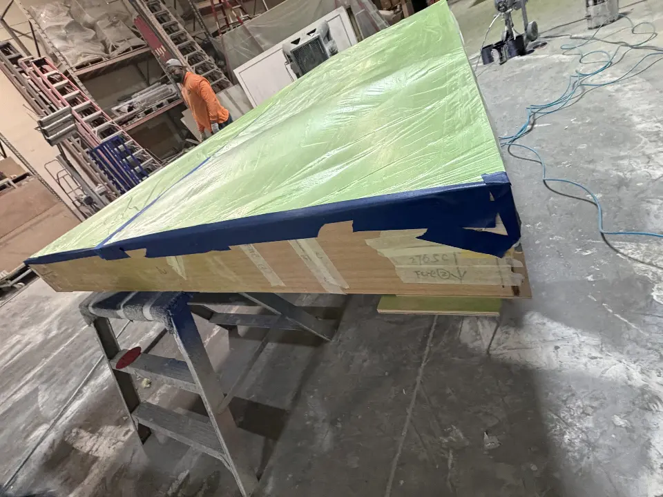 During build-up: long green ring section on trestles in the workshop