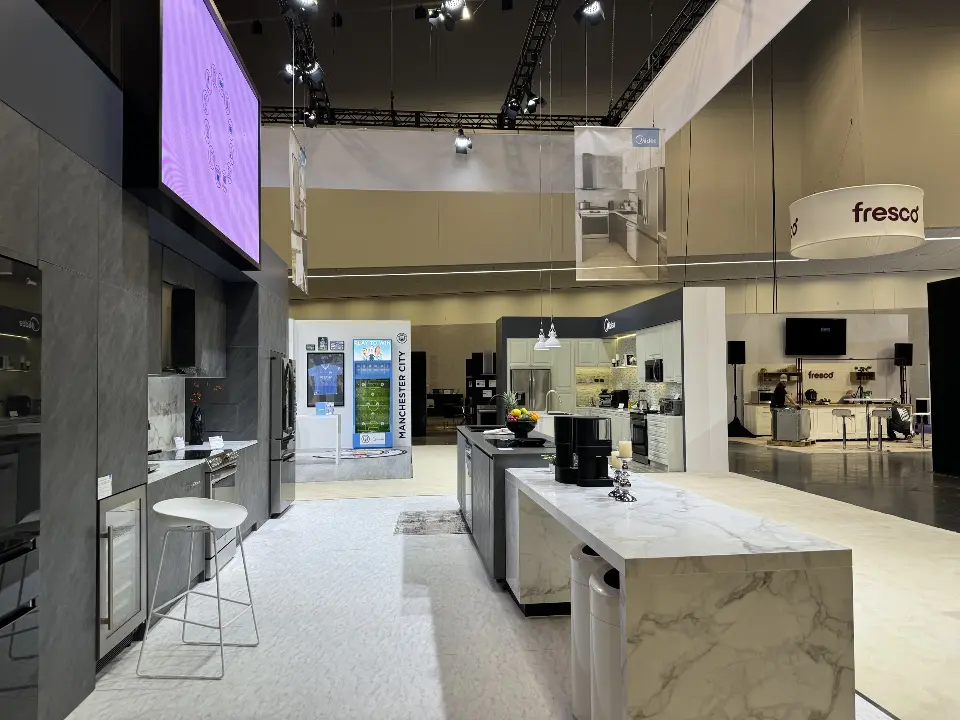 Kitchen island with bar stools under a purple-lit screen