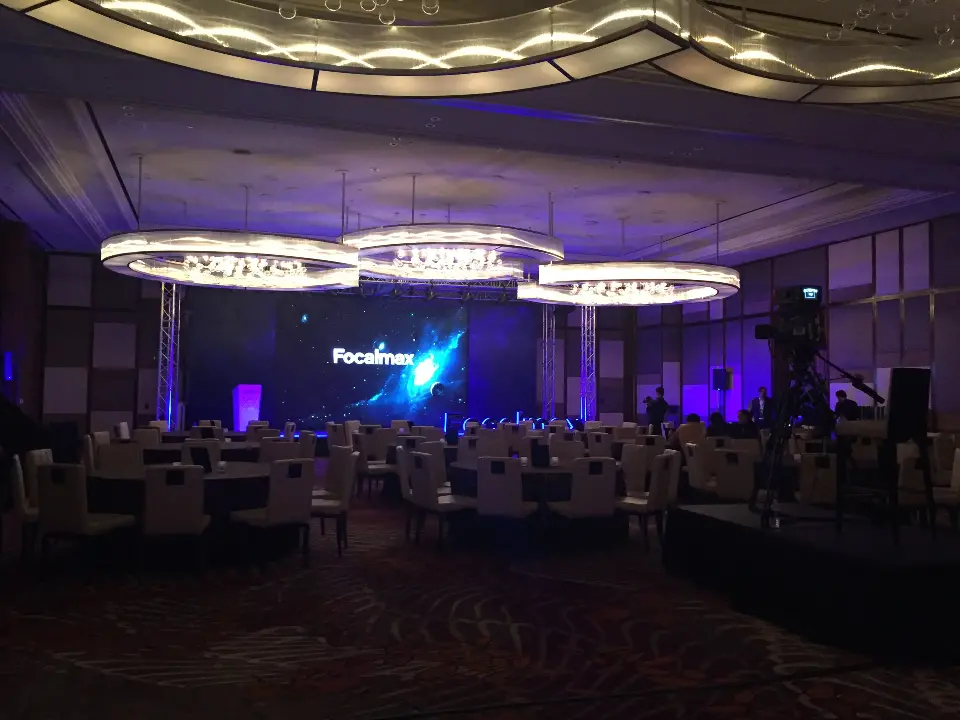 Ballroom under purple lighting with the Focalmax stage and seated guests