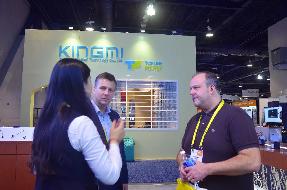 Staff and visitors talking with a neighbouring KINGMI booth behind