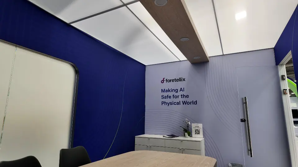Meeting room wall with the tagline and a long door handle