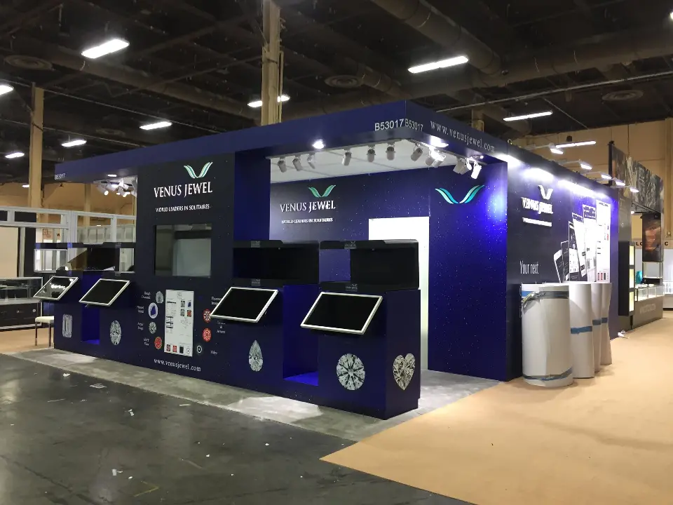 Long side of the booth with a row of angled touchscreens