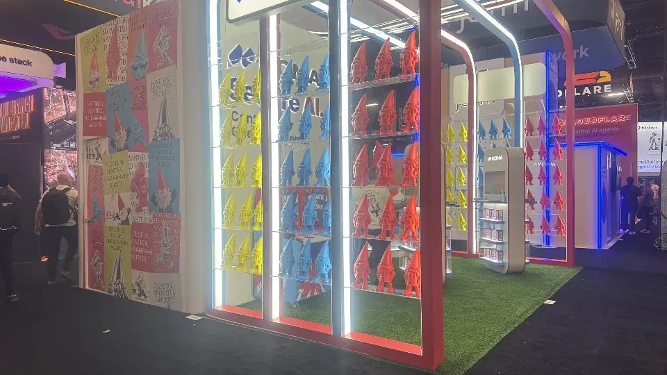Side wall packed with red, blue and yellow gnome figures behind lit frames