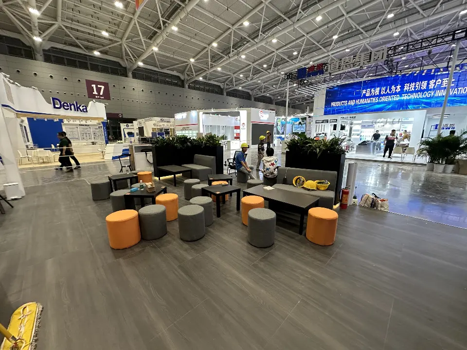 Wide view of the lounge with orange stools, sofas and coffee tables