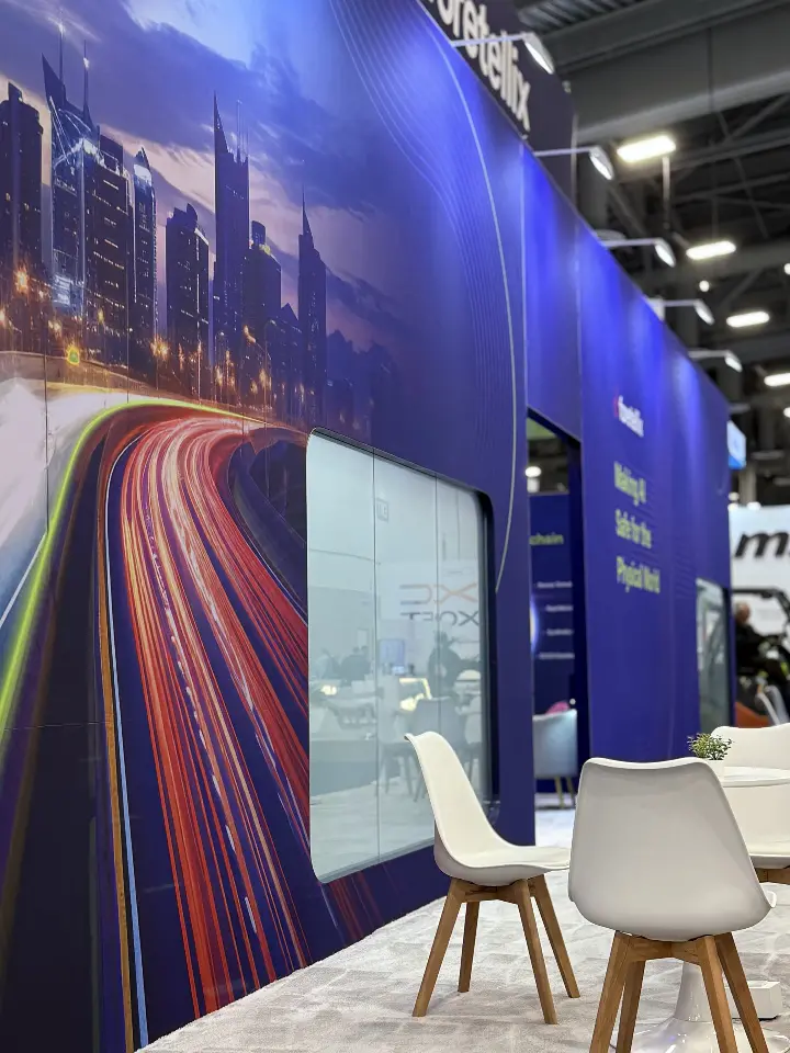 Light-trail mural with white chairs lined up in front
