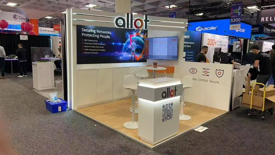 Wider view of the Allot booth at RSAC showing the graphic back wall, monitor and QR counter