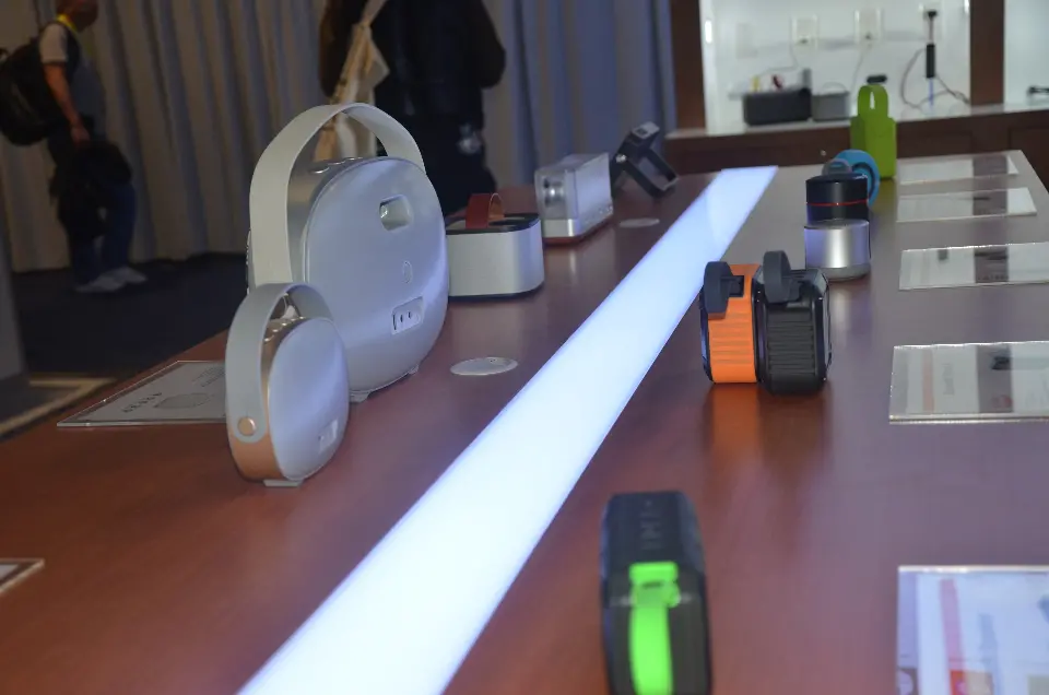 Close view of BOYYE speakers lined along a wood-look counter with a glowing centre light strip