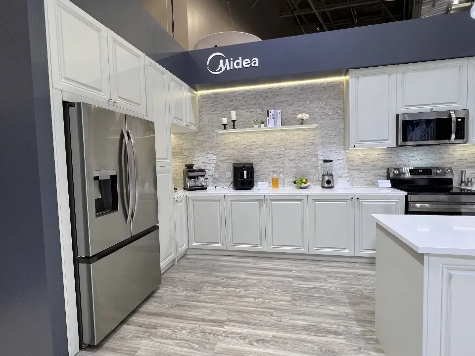 Kitchen corner with a French-door refrigerator under a Midea sign
