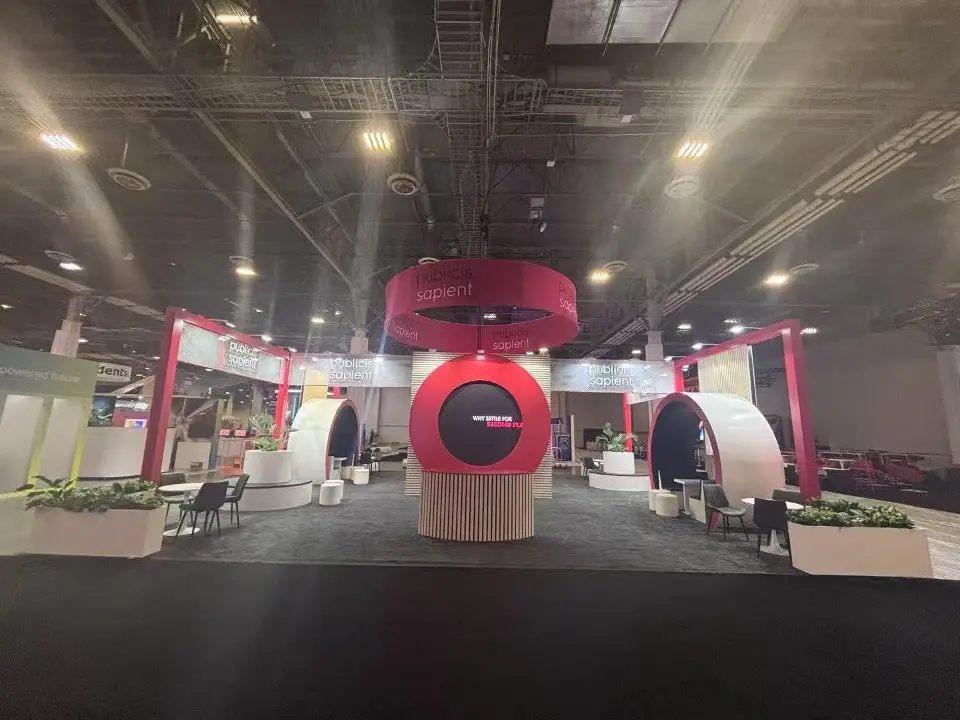 Wide view of Publicis Sapient booth with red ring pods and long planters