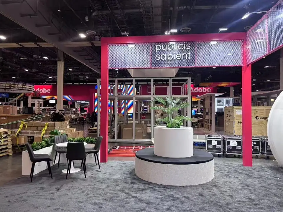 Red portal frame with publicis sapient header over a planted round bench