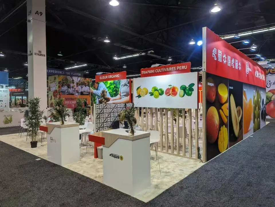 Side view of exhibitor counters with fruit graphics and potted plants