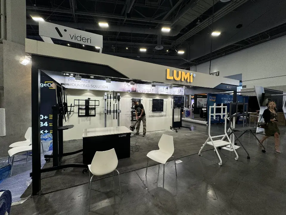 Long side view of the white canopy, LUMI lettering and white chairs on the floor