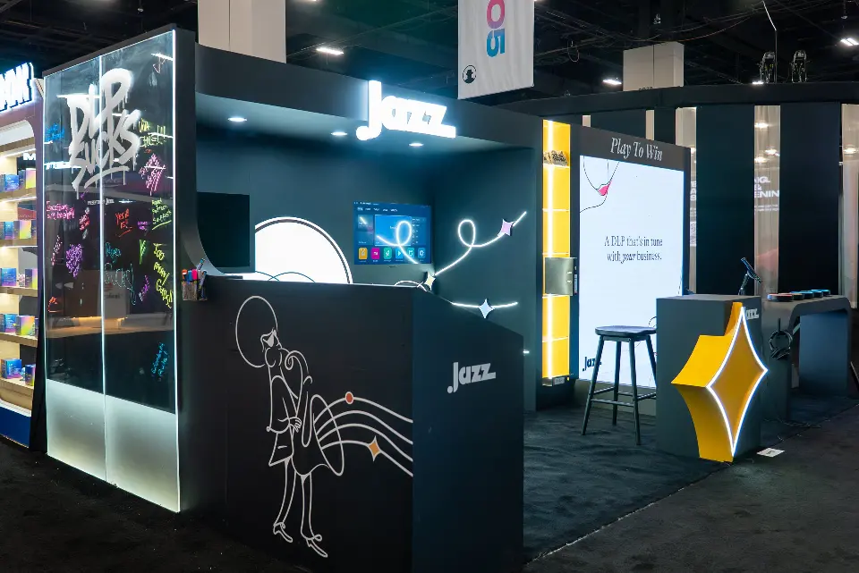 Front angle of the Jazz booth with glowing line art, wall screen and Play To Win panel