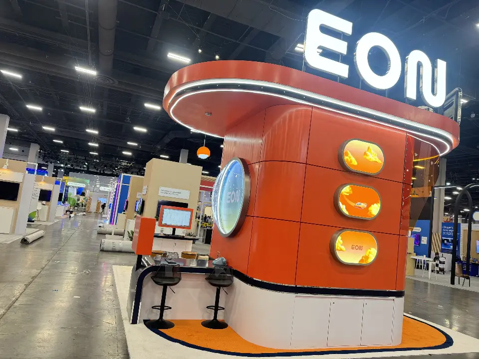 Rounded orange tower with lit portholes beneath the EON letters