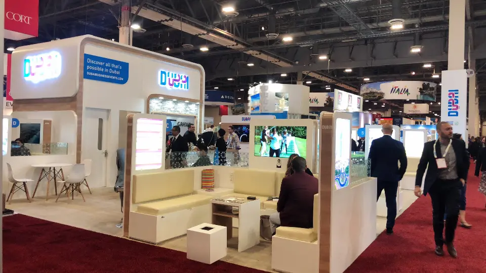 Cream lounge benches and small tables between backlit lightboxes