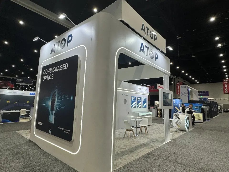 Corner of the ATOP booth with rounded white wall and co-packaged optics graphic