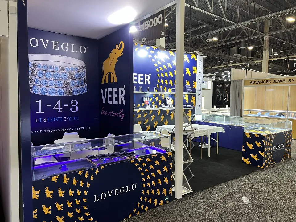 Loveglo showcase with blue-lit glass and ring graphic beside the VEER elephant logo column