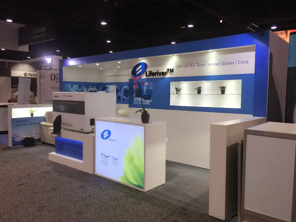 Lightbox counter close to the aisle with blue logo panel and lit niches behind