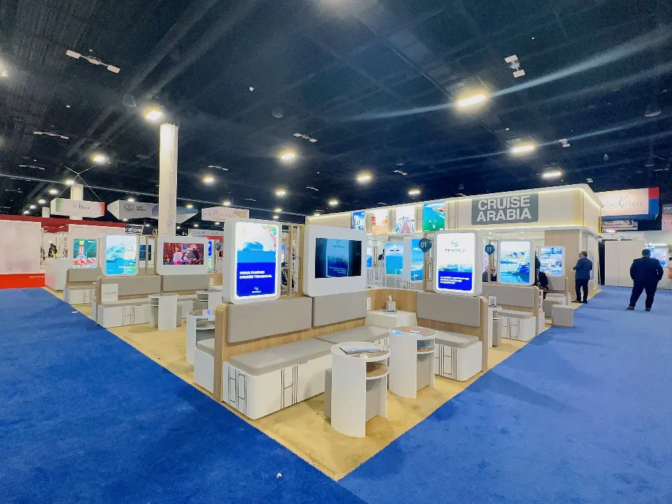 Rows of white meeting pods with backlit destination graphics overhead