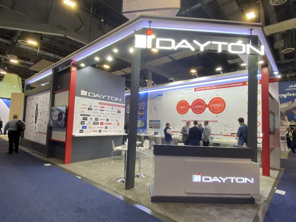 Close corner view of the logo counter, partner brand wall and meeting tables