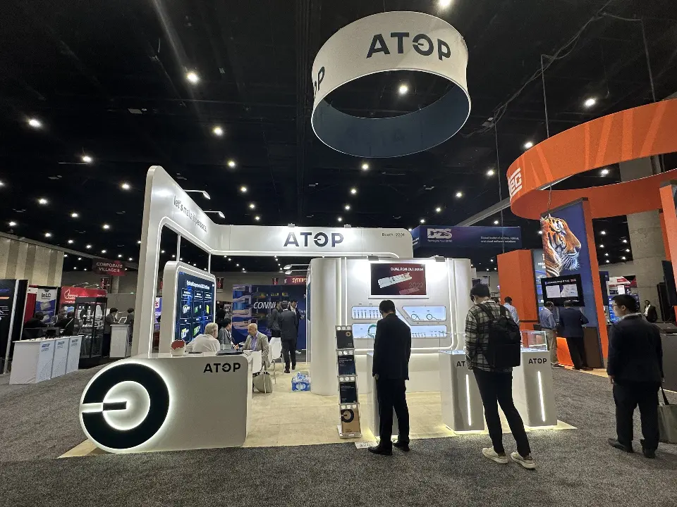 Backlit round logo counter, curved white arch and product walls under the ATOP ring