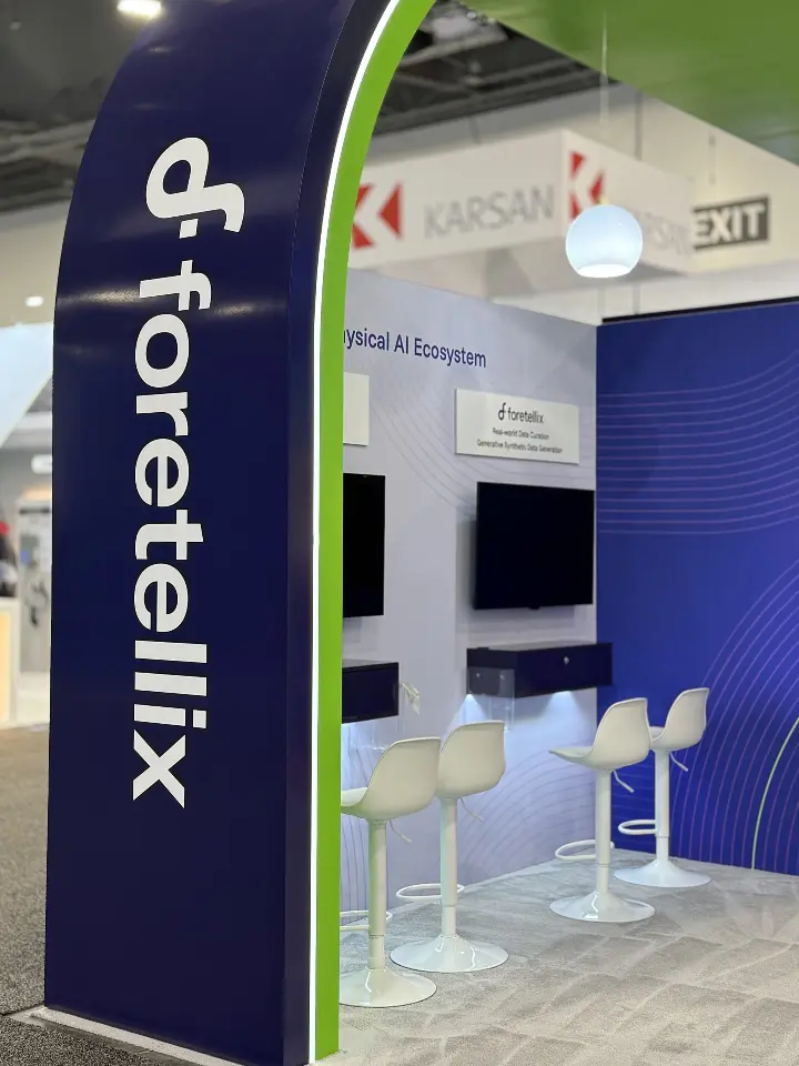 Logo column beside a wall screen and demo station