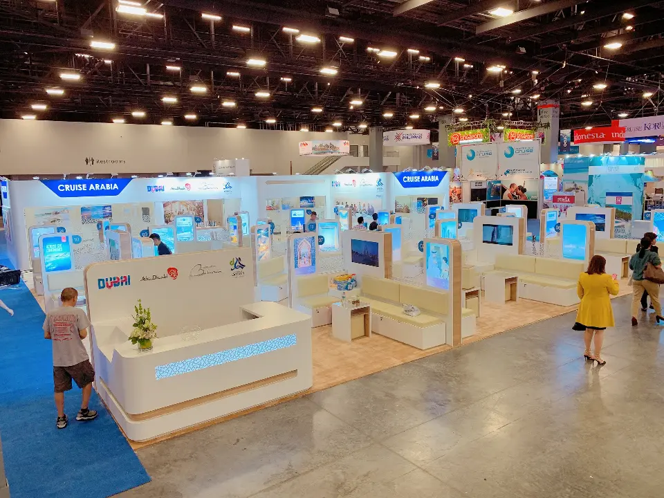 Aisle view of the booth front with a visitor walking past