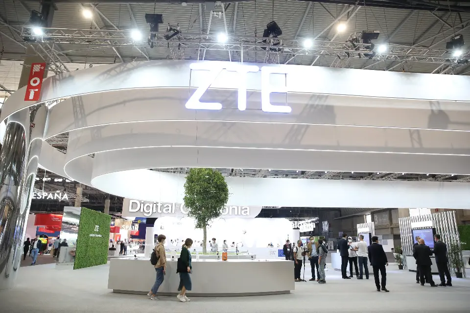 Glowing ZTE logo on the ring canopy above a white counter and tree