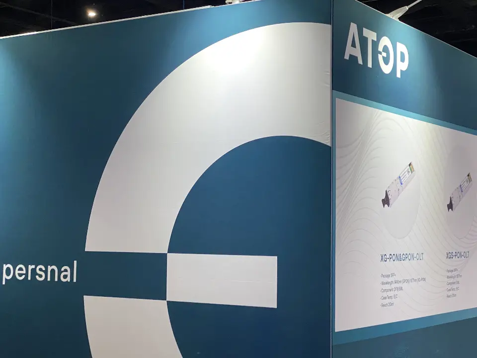 Close angle on the teal wall with oversized white circular logo graphic