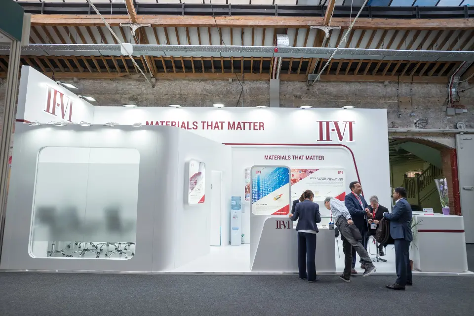 Wide view of the frosted meeting room and curved white walls with visitors at the counter