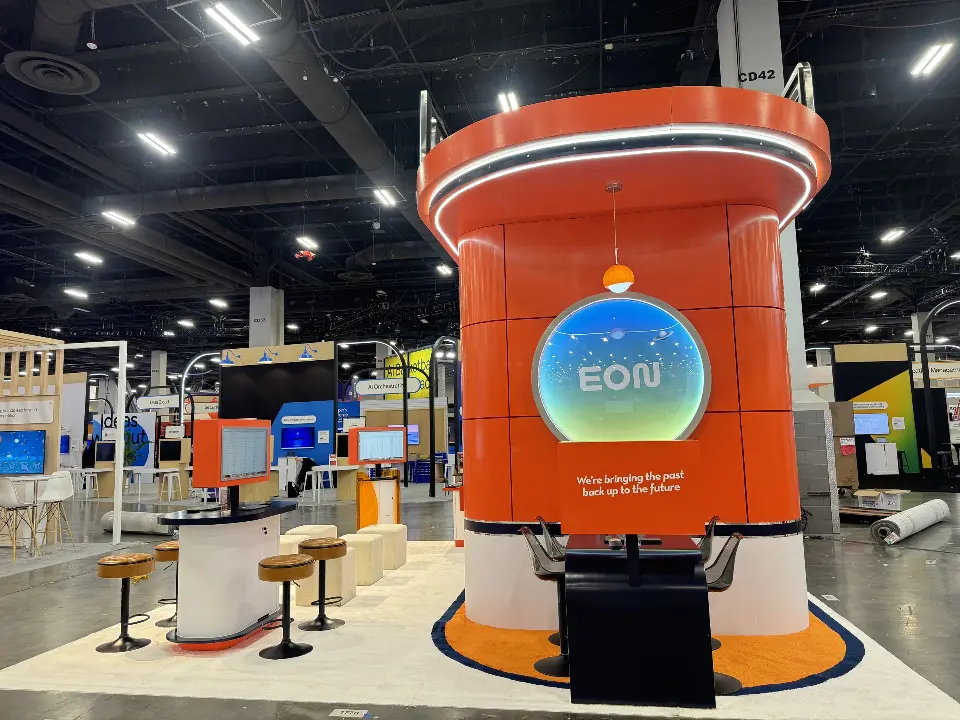 Front of the orange tower with round screen and stools