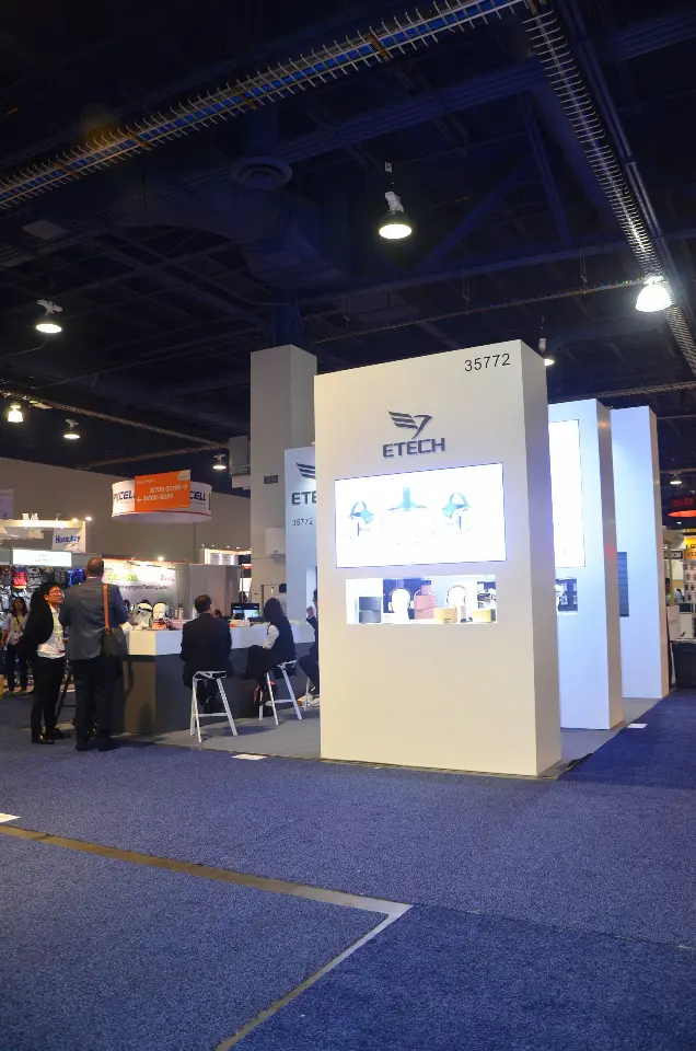 Back of a white tower with a backlit product graphic seen from the aisle