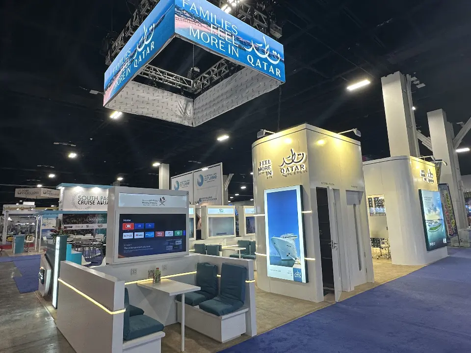 Wide view of teal lounge booths and partner screens with lit edges