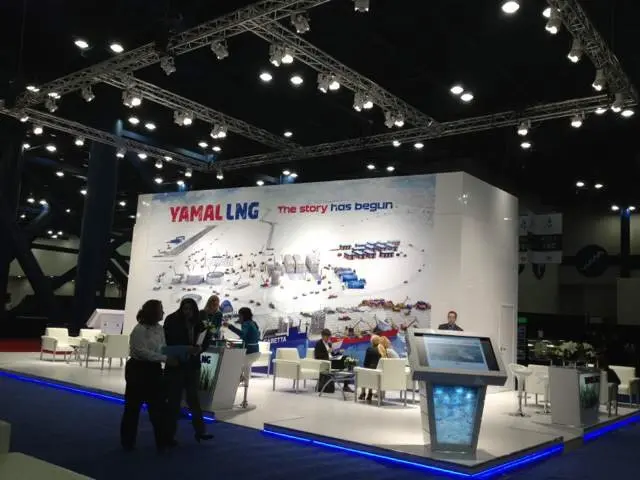 White booth with blue YAMAL LNG lettering, lounge chairs and a blue lit base edge