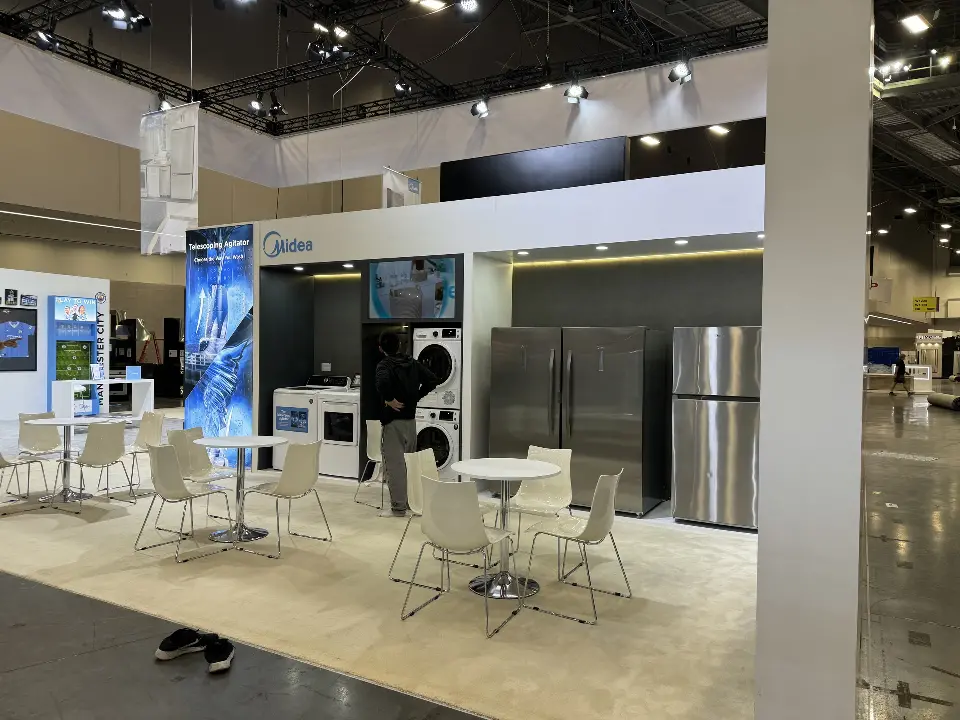 Seating area with white chairs next to a washer display
